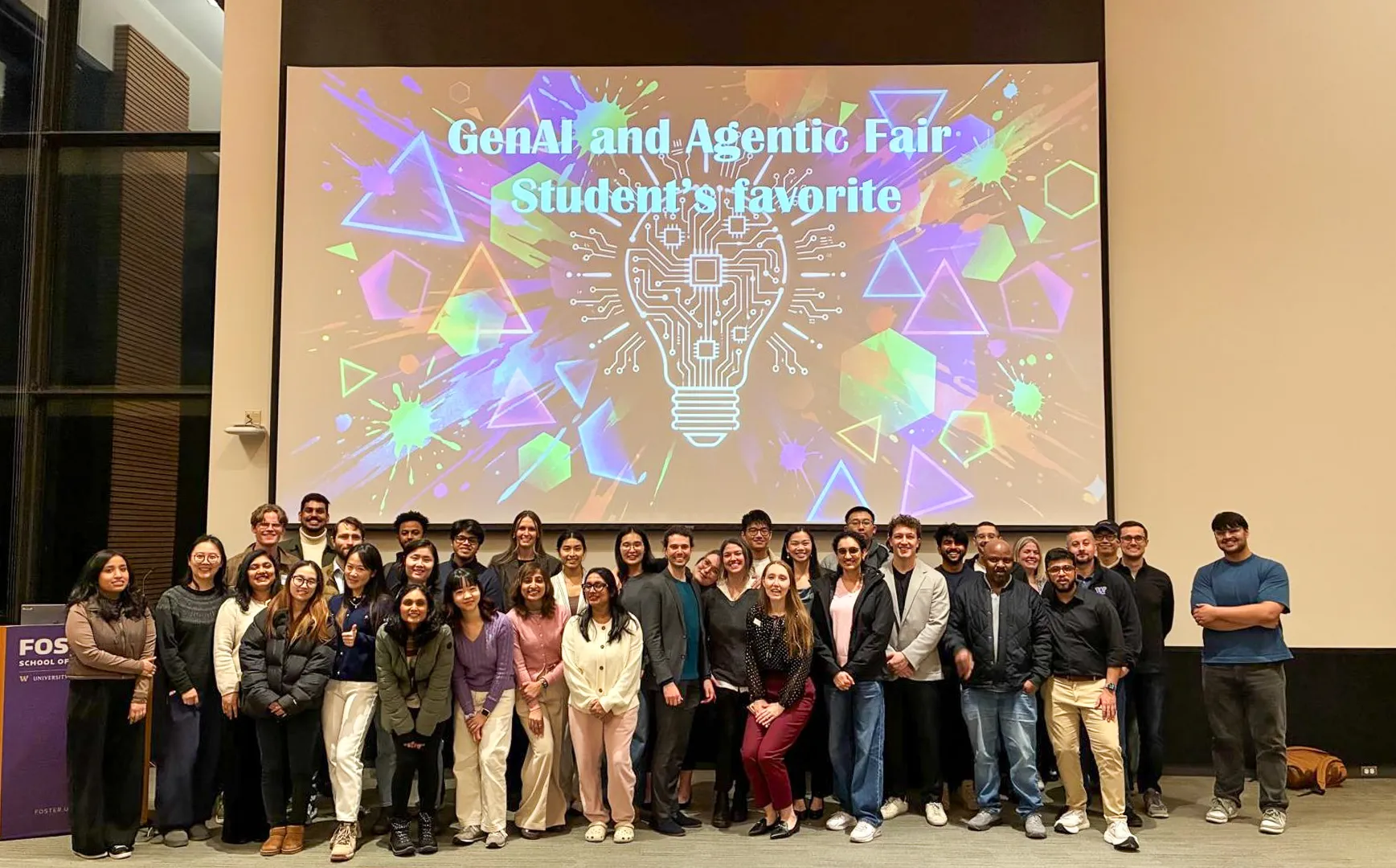 Wide group photo of all students and faculty in front of the GenAI and Agentic Fair Students' Favorite screen.