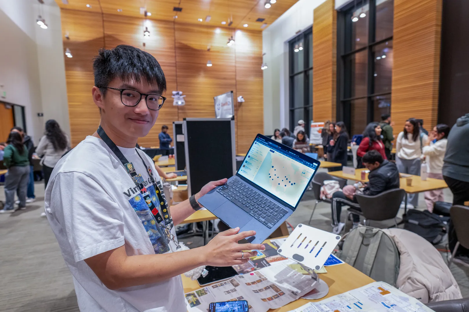 Student presenting his project on a laptop at the GenAI and Agentic Fair.