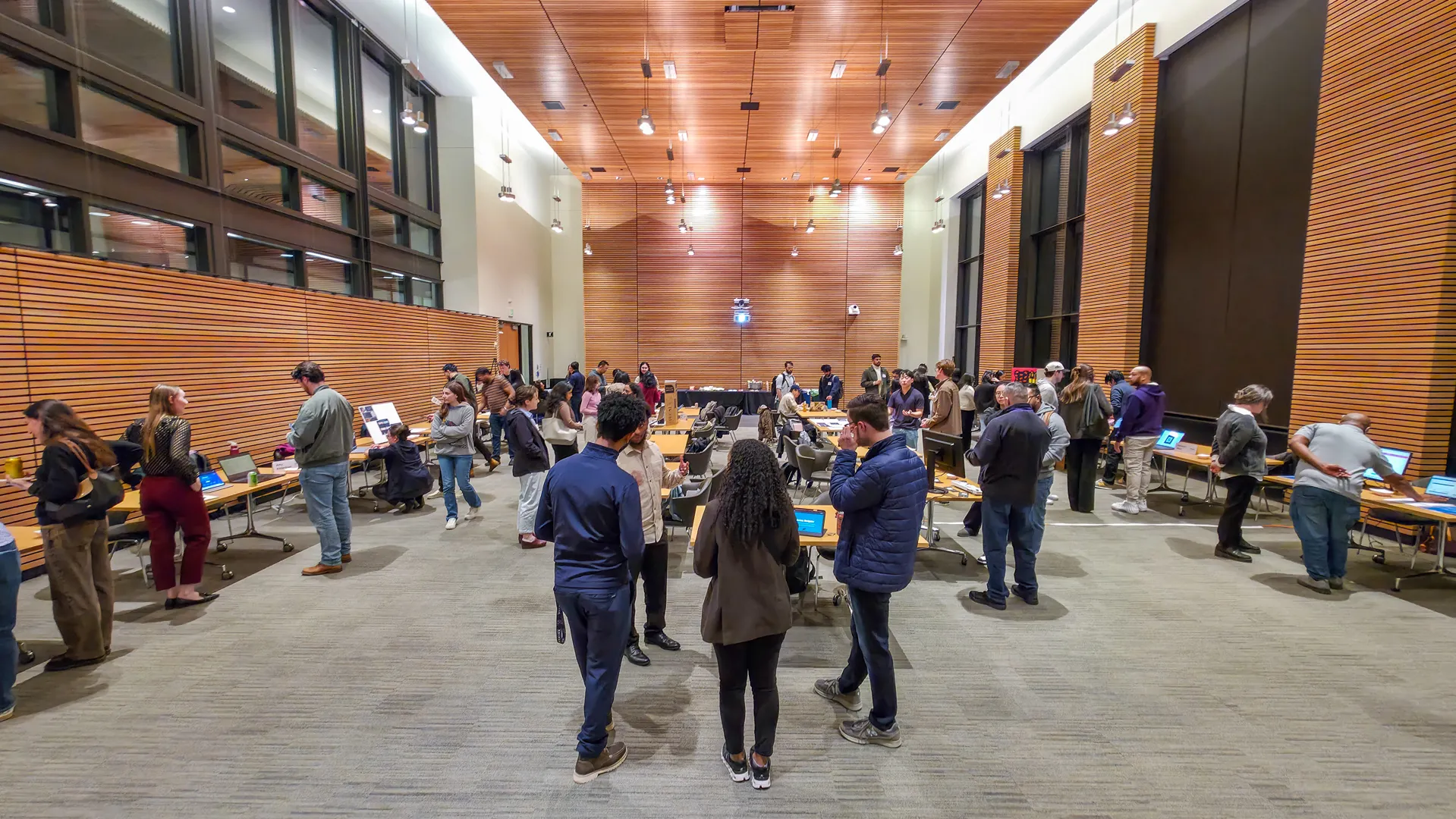 Wide view of the GenAI and Agentic Fair exhibition space with students and guests exploring projects.